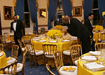 White House butlers place the finishing touches on table settings and decorations, Thursday evening, March 23, 2006 in the Blue Room of the White House, for a Social Dinner hosted by President George W. Bush and Mrs. Laura Bush in honor of the 300th Birthday of Benjamin Franklin.