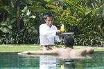 A hotel butler serving drink in Bali. Note his sarong garb.