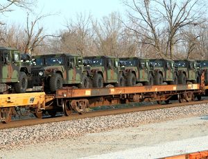 Military vehicles mounted on railway rail cars.jpg