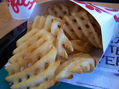 Waffle fries. Potatoes are cut crossways with a special tool to form the unique "waffle" shape, then prepared. These waffle fries are made by Chik-fil-A, a popular fast-food chain restaurant in the U.S., who is sometimes cited as popularizing the cut.