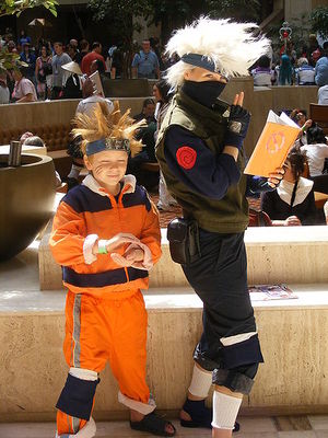 Two children dressed up in ninja costumes.