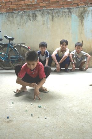 Boys in Vietnam Playing Marbles.jpg