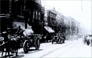 Fire engines parade down Durham, North Carolina's Main Street, in the 1910s.png