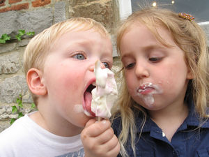 Picture of two children sharing an ice cream cone.