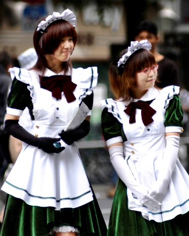 Promoting a maid-kissa (メイド喫茶 meido-kissa, 'maid coffee shop') in Akihabara, Tokyo will involve looking the part; young women in maidlike waitresses' outfits are a common sight in this electronics quarter of the city.Photo © by Sonny Santos, used by permission.