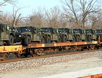 Military vehicles mounted on railway rail cars
