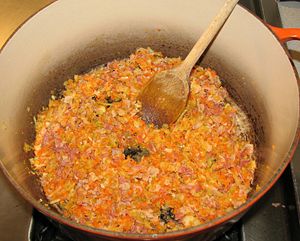 A soffrito of finely chopped onions, celery, carrots, and pancetta has been cooked in olive oil.