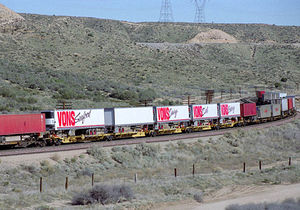 (CC) Photo: Tom Stolte / TrainWeb.com A westbound intermodal freight train passes through the Cajon Pass, Mile Post 54, in February 1995.