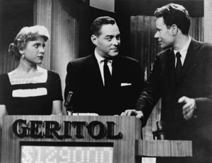 Picture of three people with the word "Geritol" on a podium.